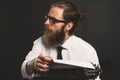 Handsome young hipster businessman thinking and writing with vintage typewriter. Royalty Free Stock Photo