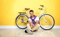 Handsome young hipster man sitting with bicycle Royalty Free Stock Photo