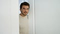Handsome young hispanic man with beard posing casually at home, looking at camera Royalty Free Stock Photo
