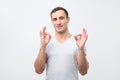 A handsome young italian man in gray t-shirt showing ok sign Royalty Free Stock Photo