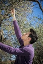 Handsome young Italian man picking olives Royalty Free Stock Photo
