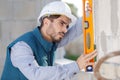 handsome young laborer with level tool Royalty Free Stock Photo