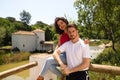 handsome young latin man and woman couple are in the forest on a wooden railing and look at each other lovingly and in love. Royalty Free Stock Photo