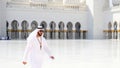 Handsome young local Arab bearded man in traditional white arabic clothes and head dress