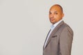 Handsome young male African American businessman in jacket looking at the camera holding his head in three quarters with Royalty Free Stock Photo