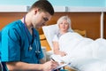 Handsome young male doctor in uniform with phonendoscope on his Royalty Free Stock Photo