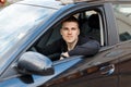 Handsome young male driver in a black car Royalty Free Stock Photo