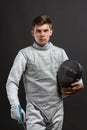 Handsome Young male fencer in white fencing costume