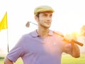 Handsome young male golfer holding club on golf course Royalty Free Stock Photo