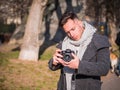 Handsome young male photographer filming video footage outside Royalty Free Stock Photo