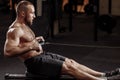 Handsome young male pulling the indoor rower Royalty Free Stock Photo