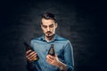 A man holds two craft bottled beers.