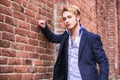 Handsome young man against brick wall Royalty Free Stock Photo