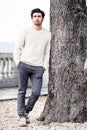 Handsome young man alone in nature near a tree outdoors Royalty Free Stock Photo