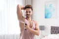 Handsome young man applying deodorant Royalty Free Stock Photo