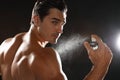 Handsome young man applying perfume Royalty Free Stock Photo