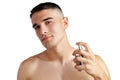 Handsome young man applying perfume on white background Royalty Free Stock Photo