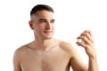 Handsome young man applying perfume on white background Royalty Free Stock Photo