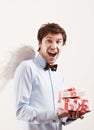 Handsome young man as cupid angel with presents Royalty Free Stock Photo