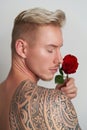 Male lover posing over the shoulder with a flower