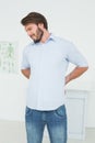 Handsome young man with back pain Royalty Free Stock Photo