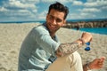 Handsome young man at the beach, smiling Royalty Free Stock Photo