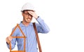 Handsome young man with bear wearing architect hardhat holding build project stressed and frustrated with hand on head, surprised Royalty Free Stock Photo