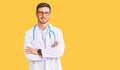 Handsome young man with bear wearing doctor uniform happy face smiling with crossed arms looking at the camera