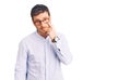 Handsome young man with bear wearing elegant business shirt and glasses pointing to the eye watching you gesture, suspicious Royalty Free Stock Photo