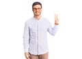 Handsome young man with bear wearing elegant business shirt and glasses showing and pointing up with fingers number three while Royalty Free Stock Photo