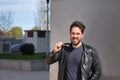 Handsome young man with beard, leather jacket, smiling while biting the temple of sunglasses looking at the camera. Concept beauty Royalty Free Stock Photo