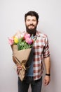 Handsome young man with beard and nice bouquet of flowers Royalty Free Stock Photo