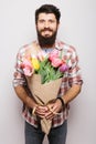 Handsome young man with beard and nice bouquet of flowers Royalty Free Stock Photo