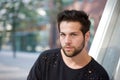 Handsome young man with beard posing outdoors