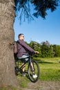 Handsome young man with bicycle in the park on a sunny day Royalty Free Stock Photo