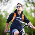 Handsome young man biking Royalty Free Stock Photo