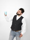 Handsome, young man with black beard posing with turquoise coffee cup or tea cup in front of white background