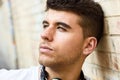 Handsome young man with blue eyes posing near a wall Royalty Free Stock Photo