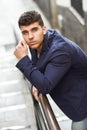 Handsome young man with blue eyes posing near a wall Royalty Free Stock Photo