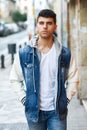 Handsome young man with blue eyes posing near a wall Royalty Free Stock Photo