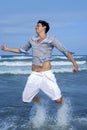 Handsome young man on the blue ocean beach Royalty Free Stock Photo