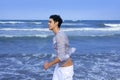 Handsome young man on the blue ocean beach Royalty Free Stock Photo