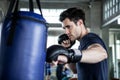 Handsome young man boxer is exercising with a punching bag at training fitness gym.male boxing workout sport Royalty Free Stock Photo