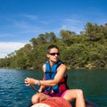 Handsome young man on a canoe on a lake