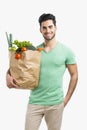 Man carrying a bag full of vegetables Royalty Free Stock Photo