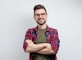 Handsome young man in casual shirt keeping arms crossed and smiling Royalty Free Stock Photo