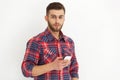Handsome young man in casual wear typing text message. Royalty Free Stock Photo