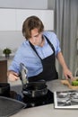 Handsome young man checking a pot at a kitchen Royalty Free Stock Photo