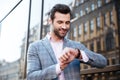 Handsome young man checking the time on his wrist watch Royalty Free Stock Photo