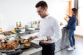 Handsome young man choosing dessert at a buffet in dining room of the hotel Royalty Free Stock Photo